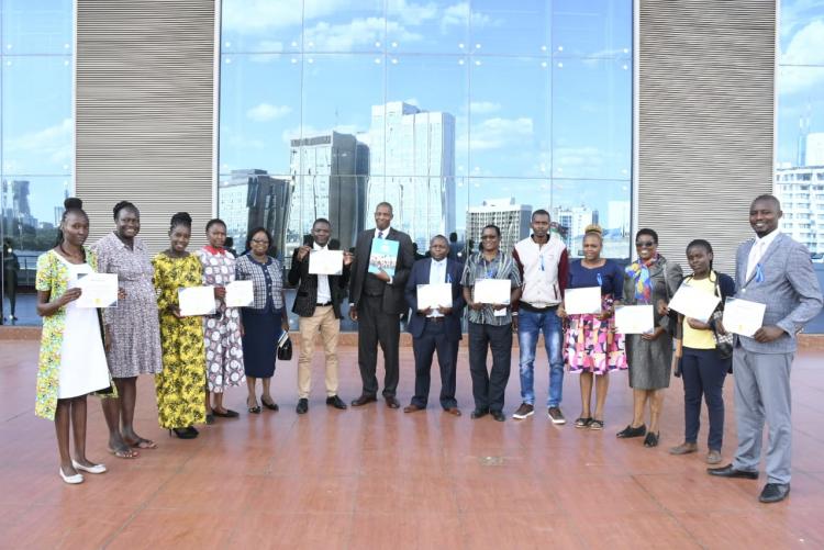 Course participants pose for a group photograph with their certificate awards